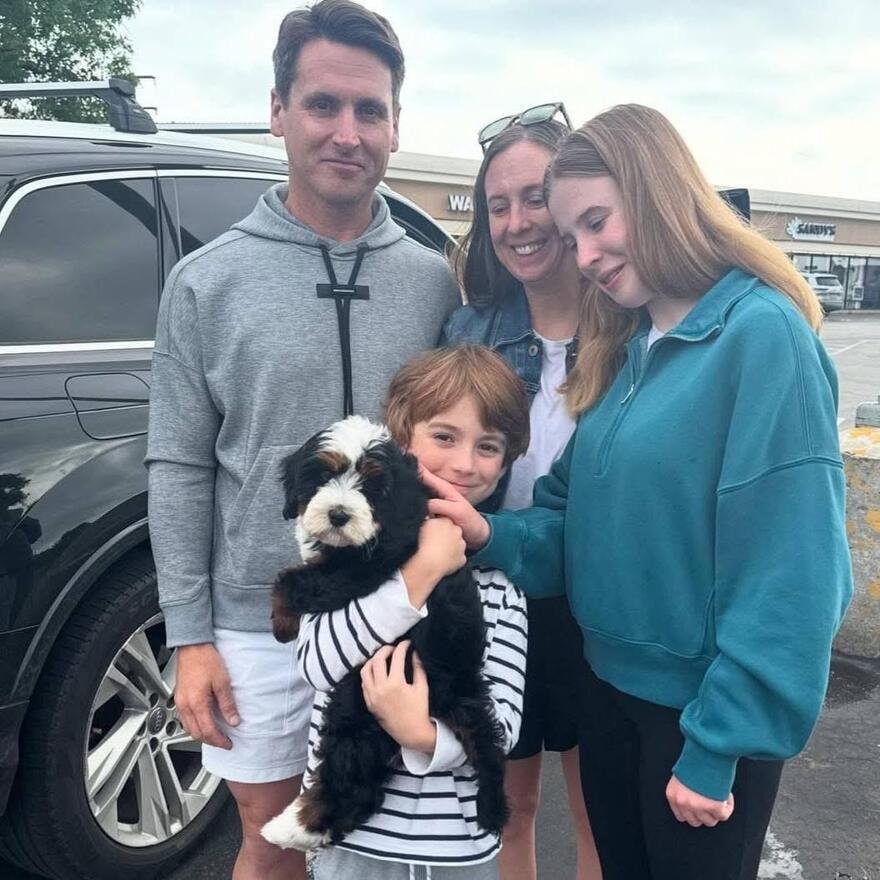 Happy family with puppy